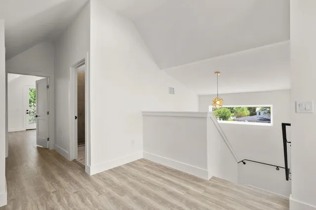 a view of an entryway with wooden floor