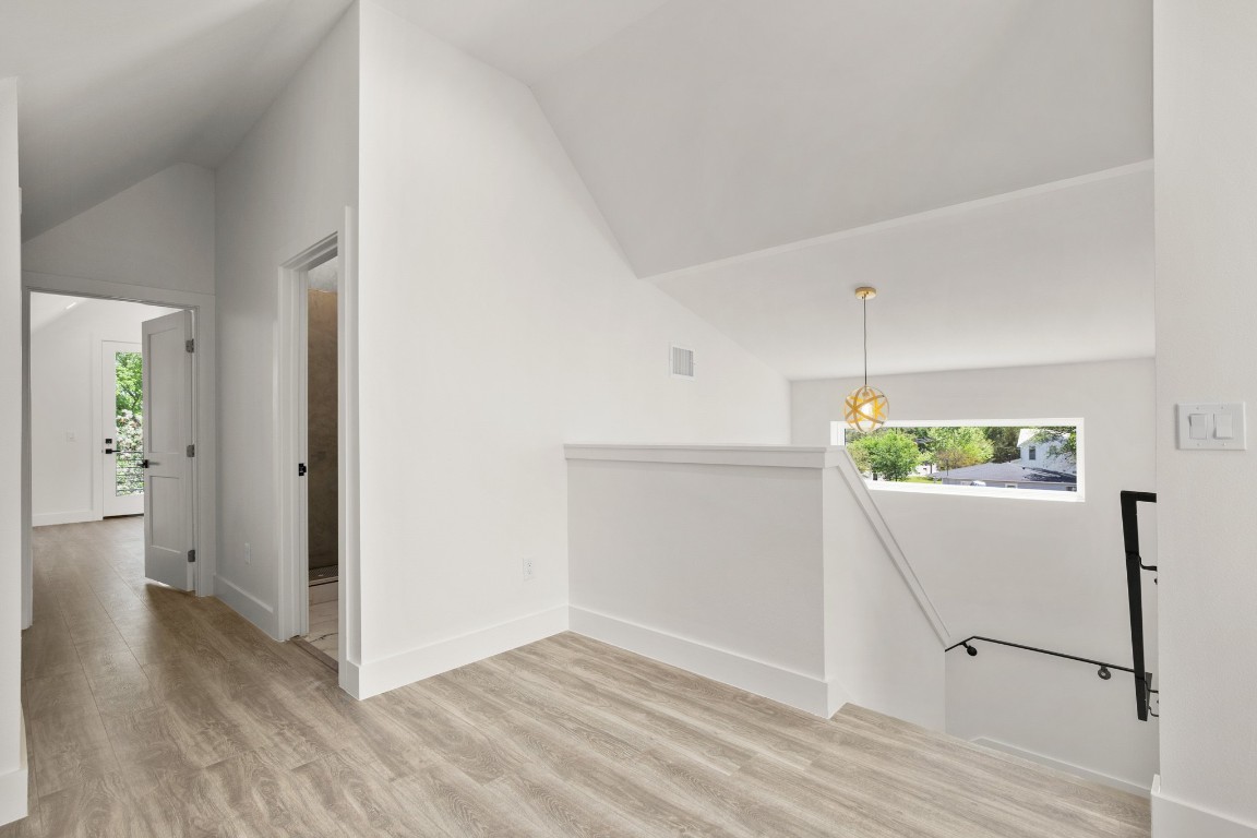 1606 Harvey Street, Unit 1 Austin, TX 78702 - Photo 22 of 33 a view of an empty room with wooden floor and a window