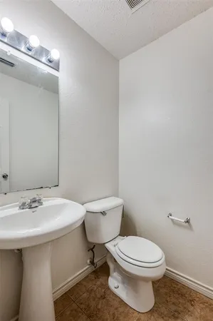 a white toilet sitting next to a bathroom sink