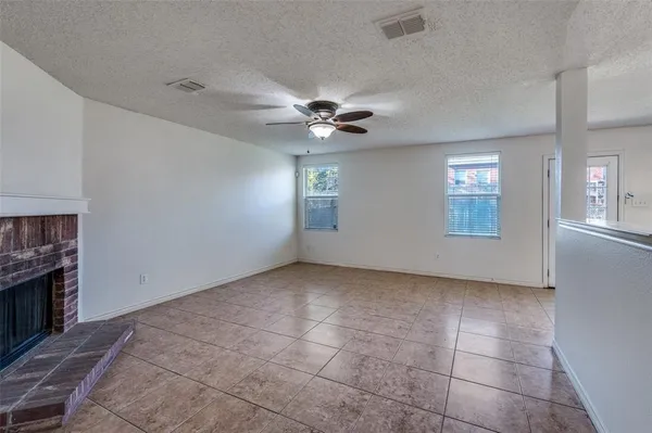 a view of an empty room with a kitchen