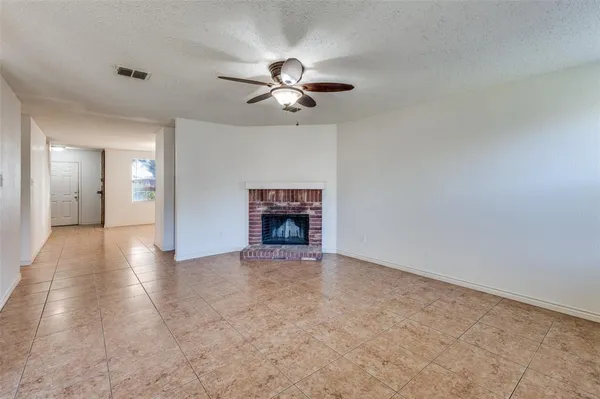 a view of an empty room with a fireplace