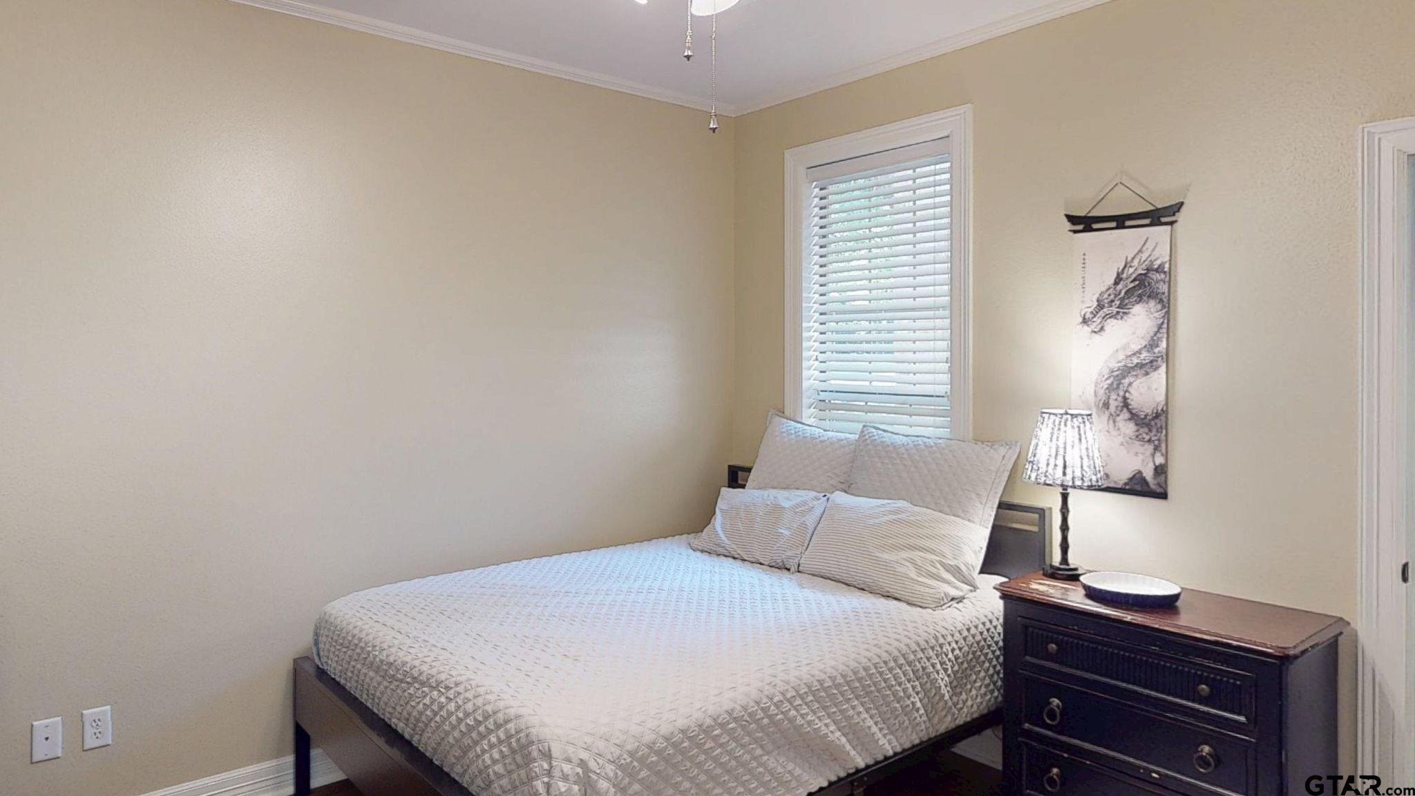 18488 Bluebird Circle Flint, TX 75762 - Photo 33 of 47 a bedroom with a bed and a lamp on the dresser