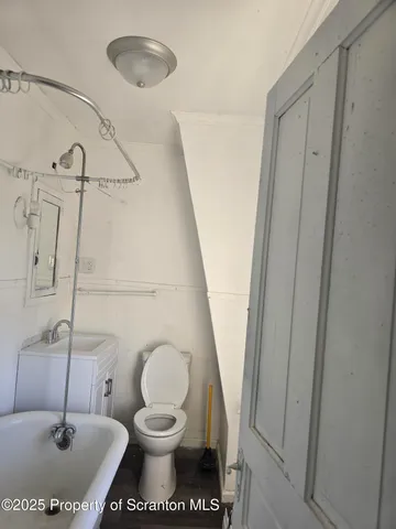 a bathroom with a toilet and a sink