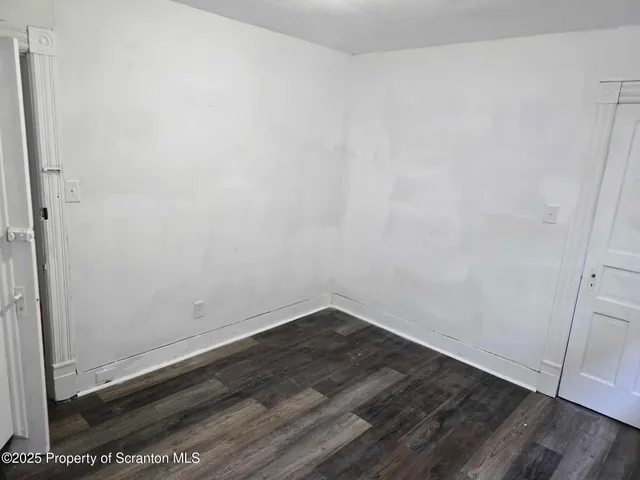 an empty room with wooden floor