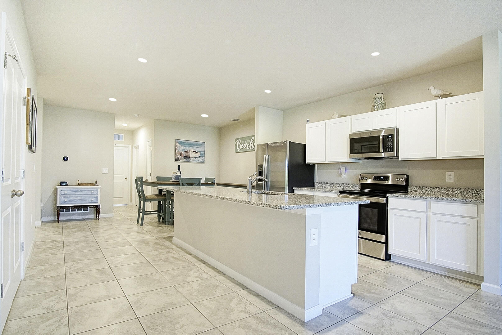 266 Raspberry Road Fort Pierce, FL 34981 - Photo 23 of 34 a kitchen with stainless steel appliances granite countertop a refrigerator and a stove top oven