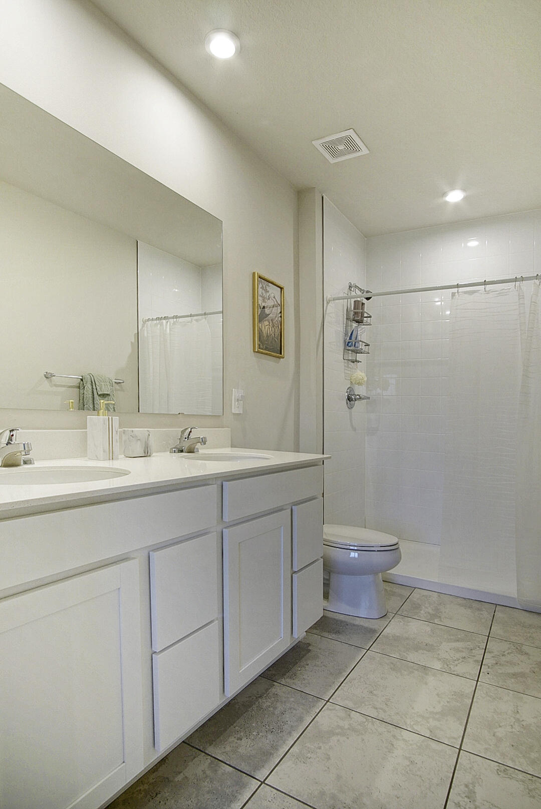 266 Raspberry Road Fort Pierce, FL 34981 - Photo 29 of 34 a bathroom with a double vanity sink a toilet and a mirror