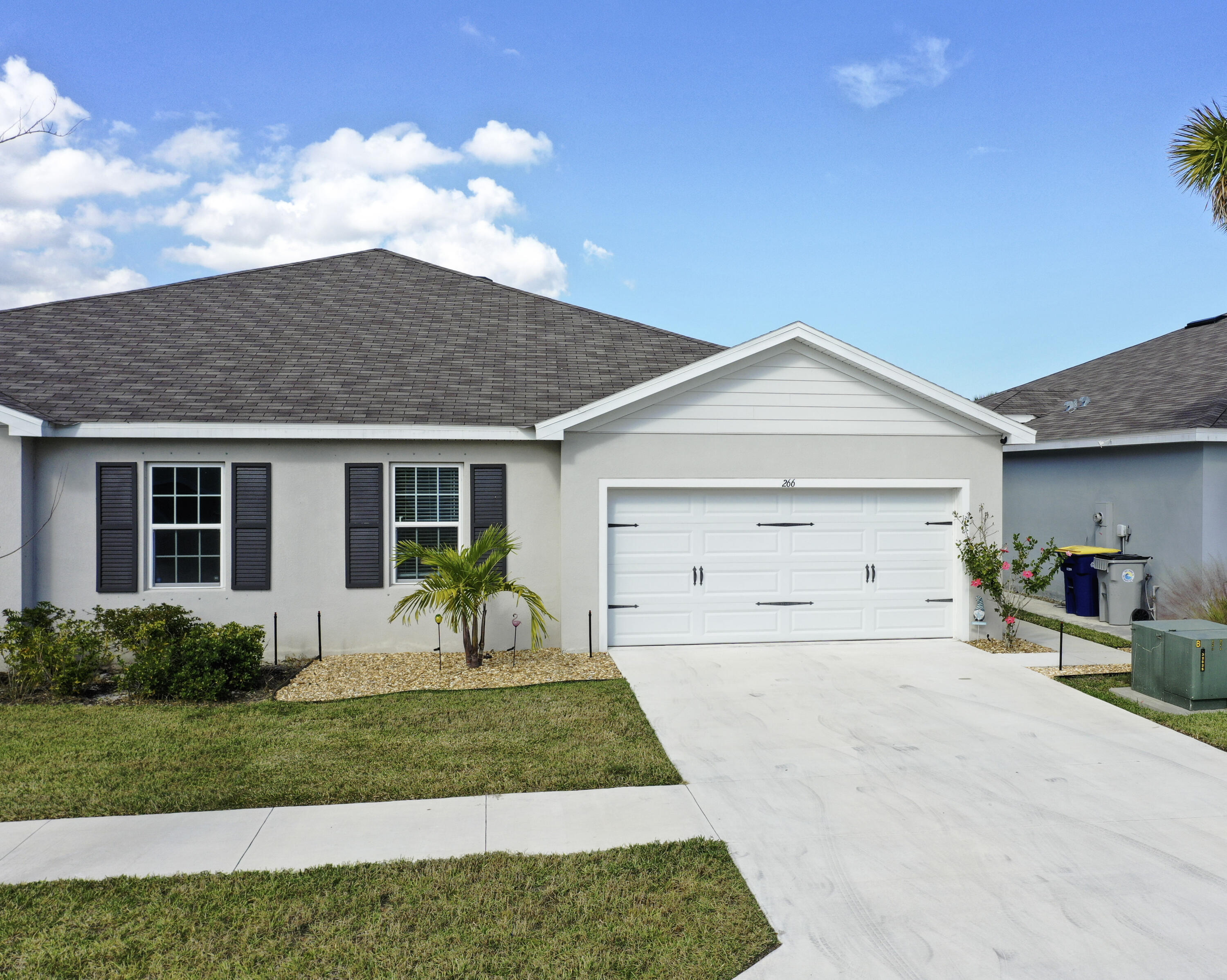 266 Raspberry Road Fort Pierce, FL 34981 - Photo 3 of 34 a front view of a house with a garden and plants