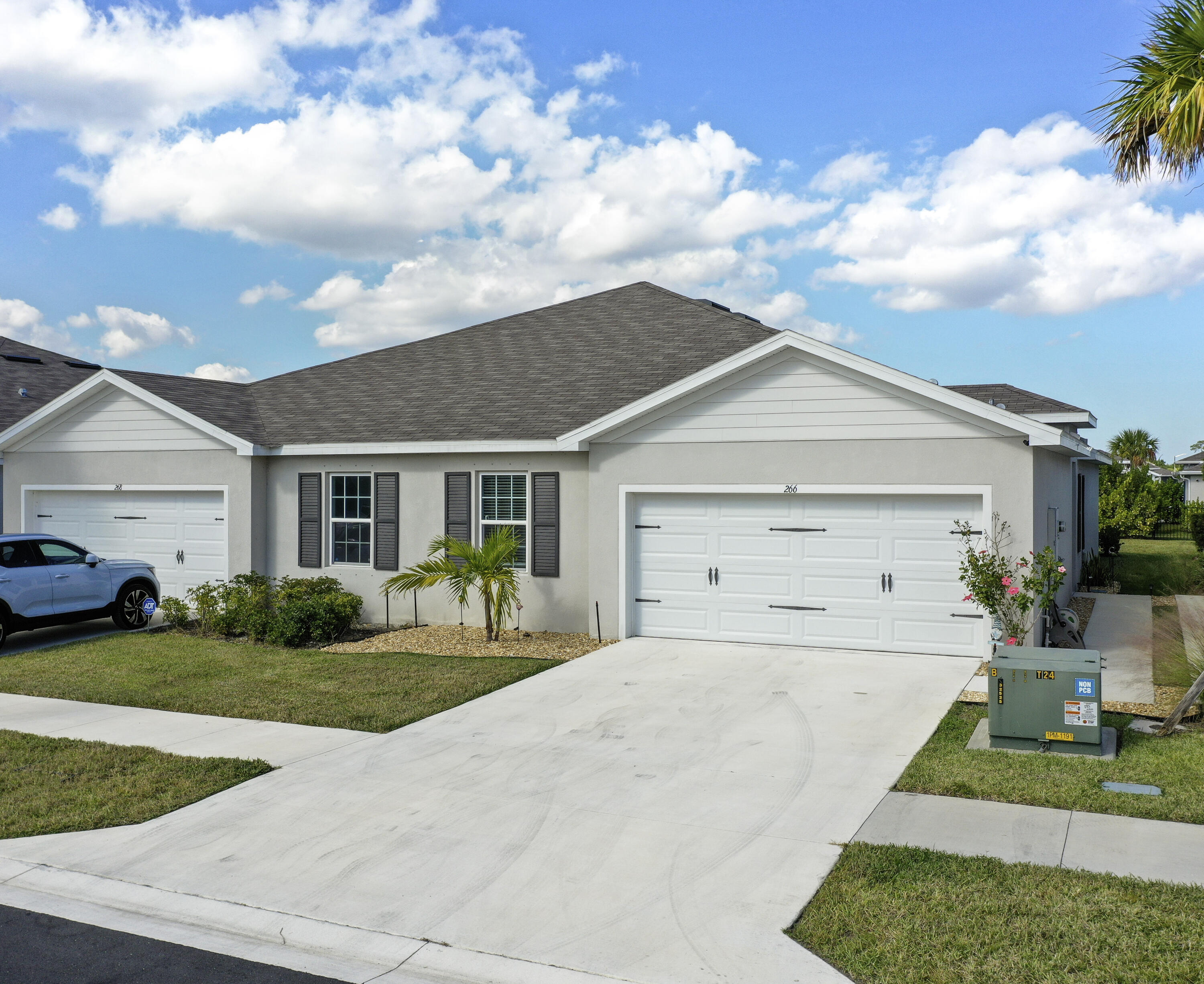 266 Raspberry Road Fort Pierce, FL 34981 - Photo 4 of 34 a front view of a house with a yard and garage