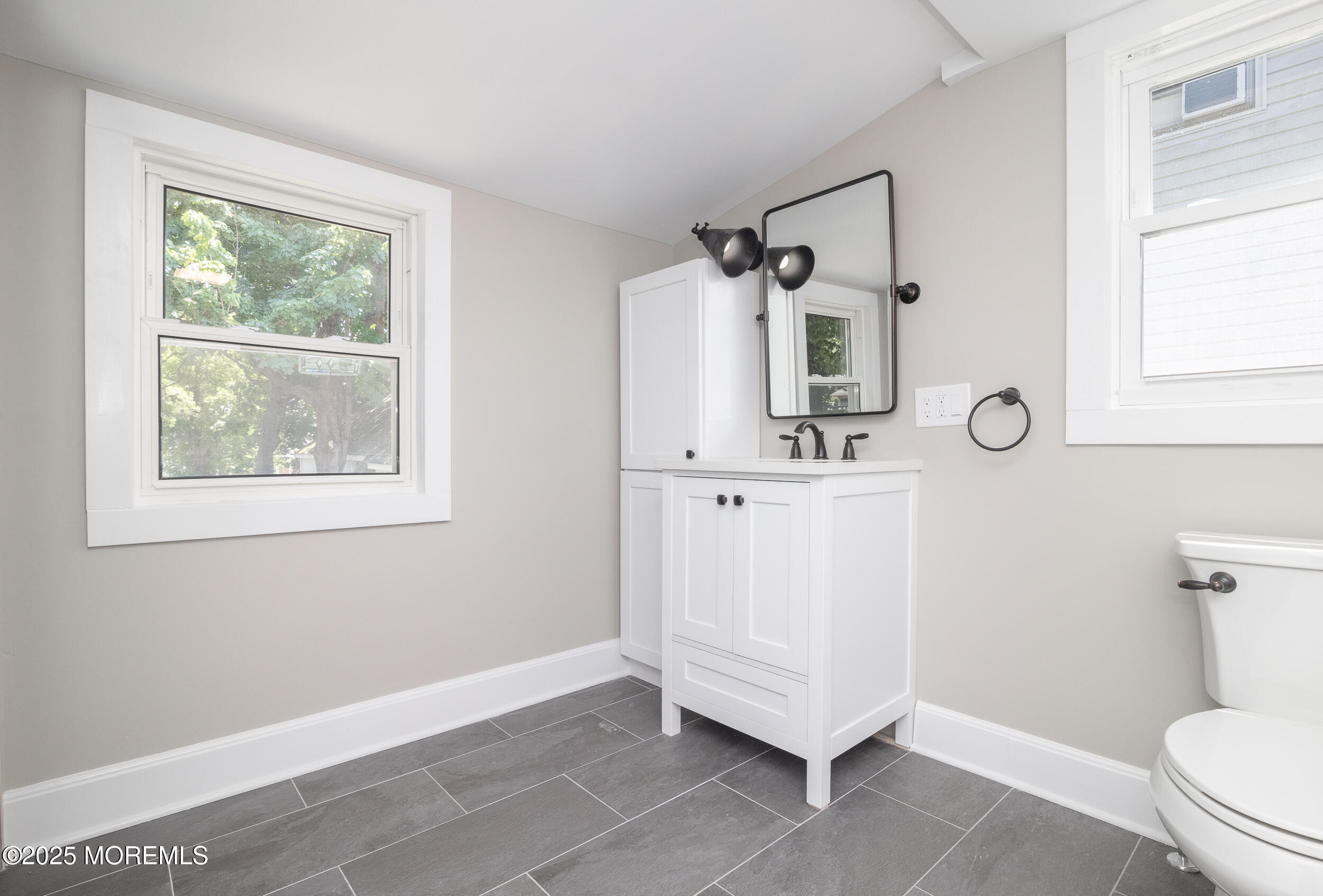 30 Conover Street Freehold, NJ 07728 - Photo 12 of 39 a bathroom with a sink a toilet and a mirror