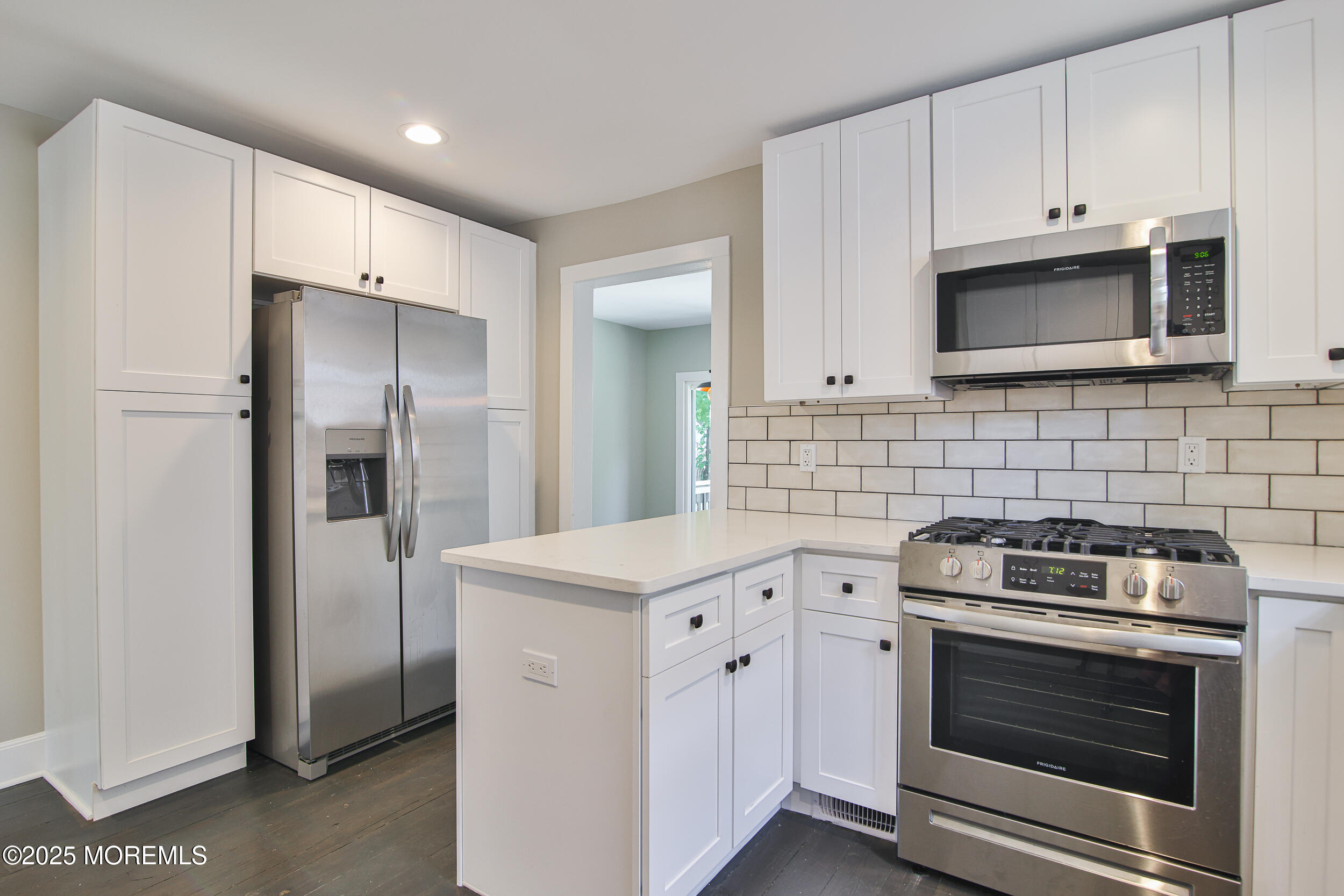 30 Conover Street Freehold, NJ 07728 - Photo 16 of 39 a kitchen with white cabinets and stainless steel appliances