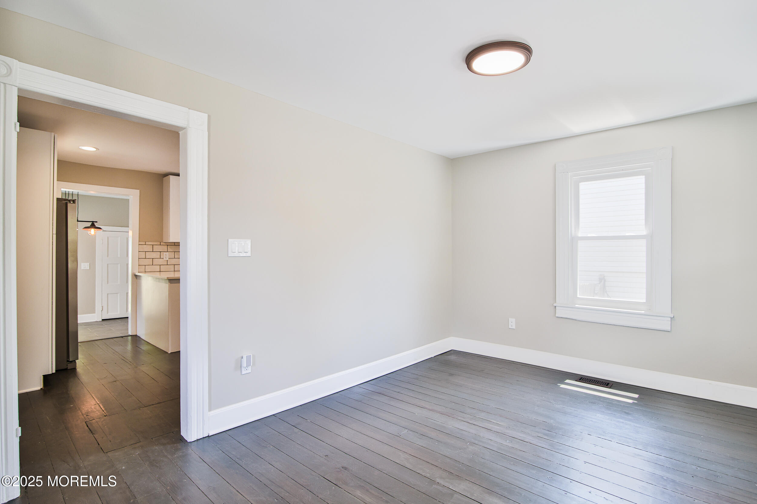 30 Conover Street Freehold, NJ 07728 - Photo 22 of 39 an empty room with wooden floor and a window