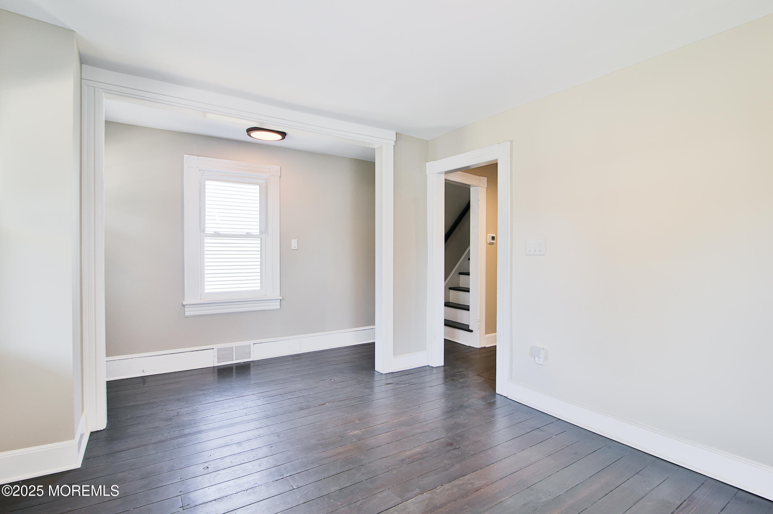 30 Conover Street Freehold, NJ 07728 - Photo 23 of 39 an empty room with wooden floor and windows