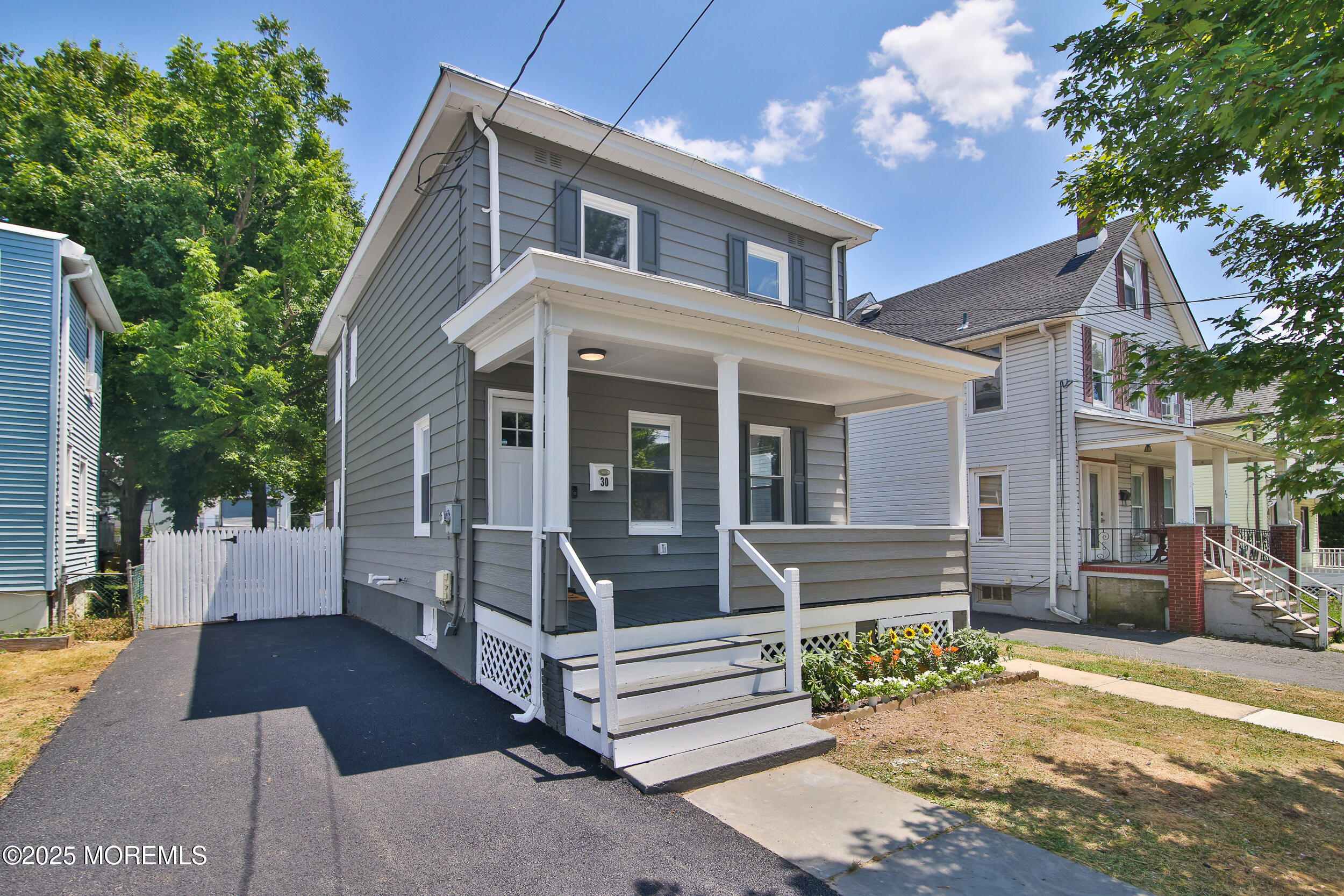 30 Conover Street Freehold, NJ 07728 - Photo 39 of 39 a view of a white house with a large tree and a yard with plants