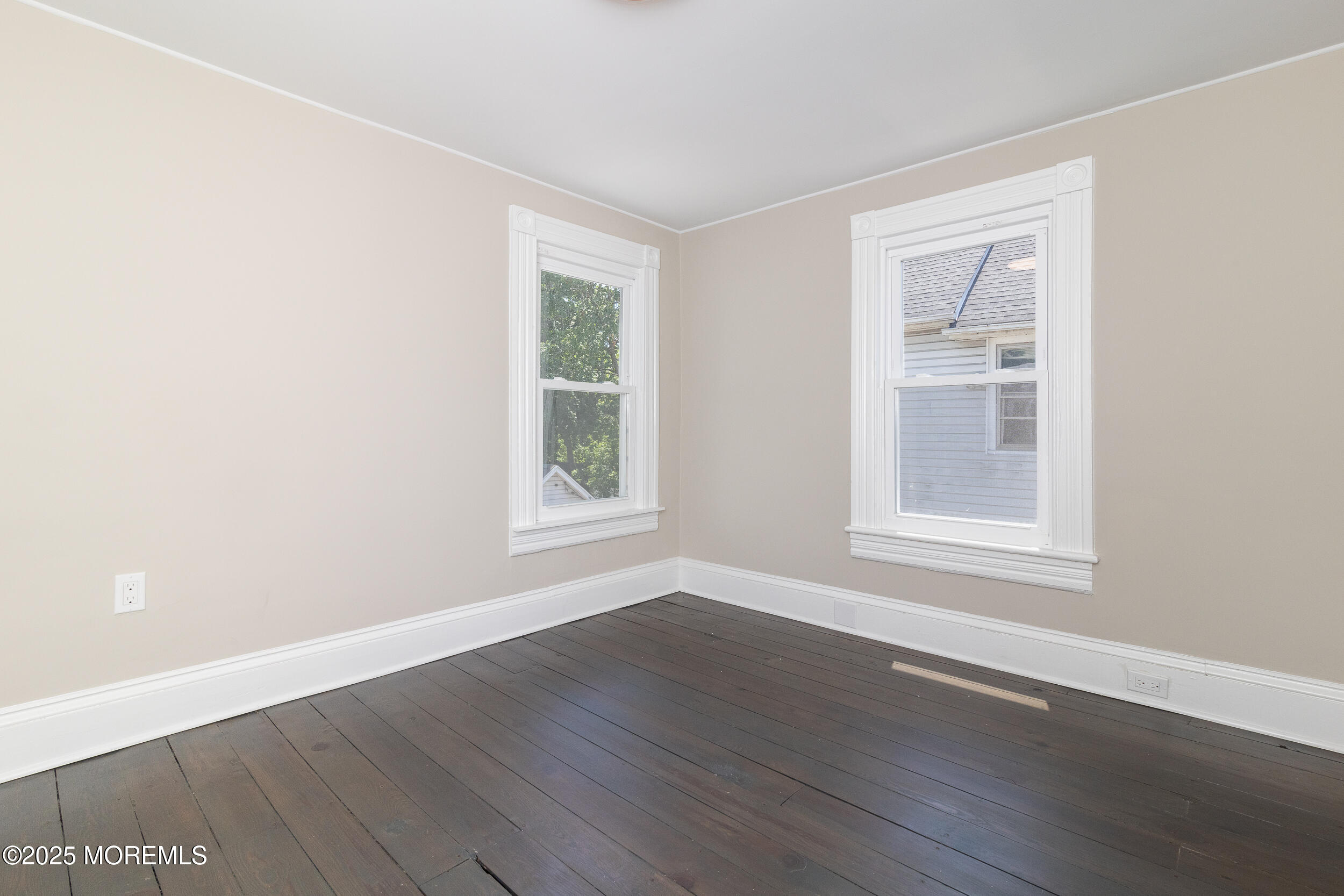 30 Conover Street Freehold, NJ 07728 - Photo 4 of 39 an empty room with wooden floor and windows
