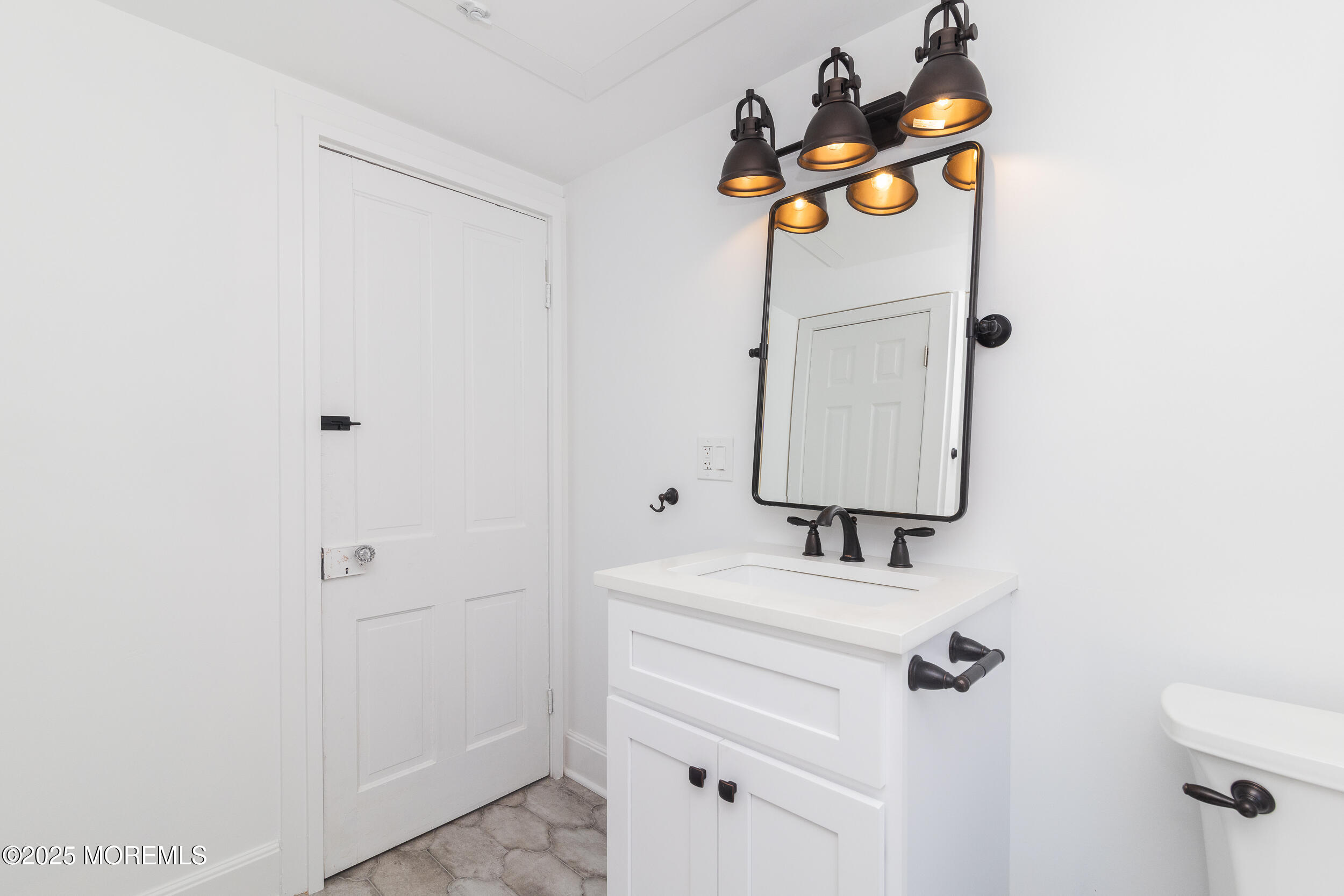 30 Conover Street Freehold, NJ 07728 - Photo 6 of 39 a bathroom with a sink vanity and a mirror