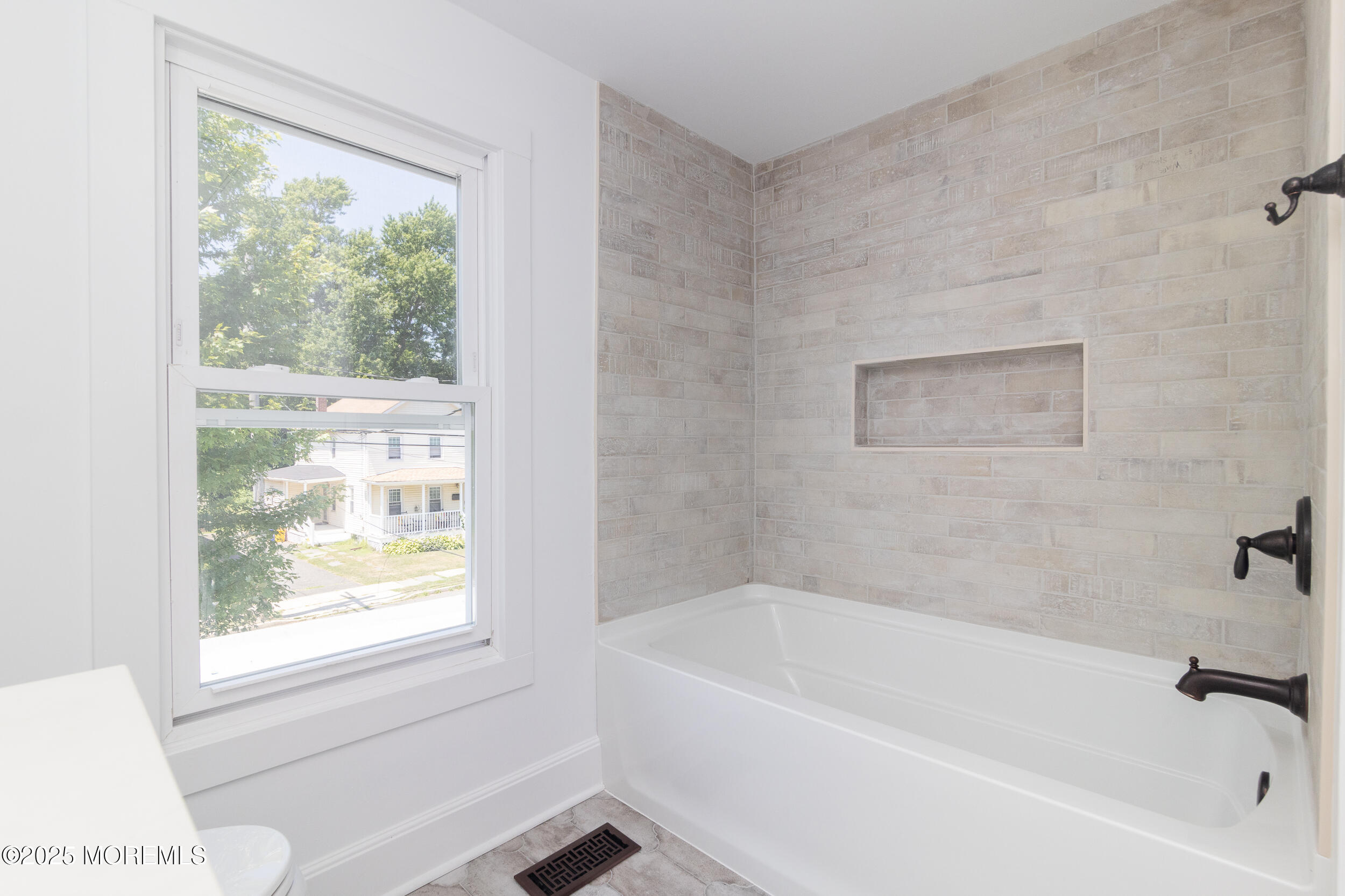 30 Conover Street Freehold, NJ 07728 - Photo 7 of 39 a white bath tub sitting next to a window
