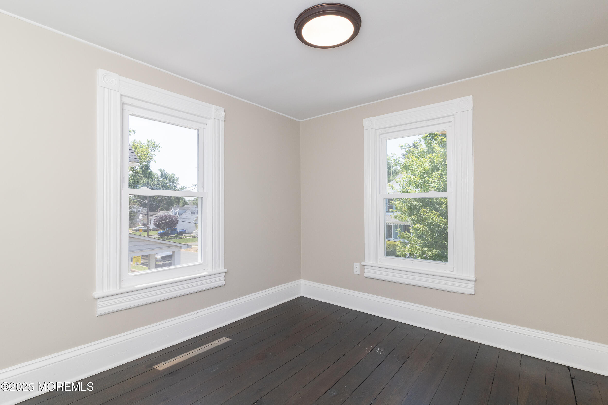 30 Conover Street Freehold, NJ 07728 - Photo 9 of 39 an empty room with wooden floor and windows