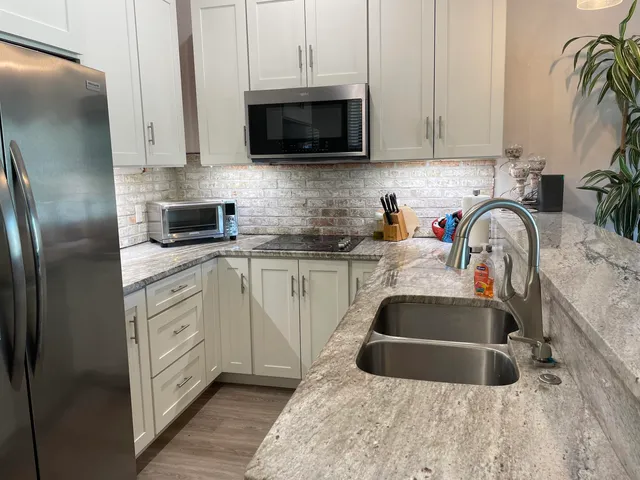 a kitchen with white cabinets and a sink