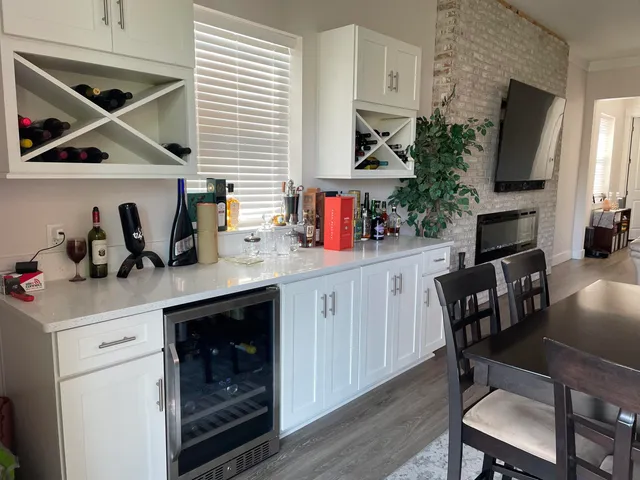 a large kitchen with granite countertop a large counter top stainless steel appliances and cabinets