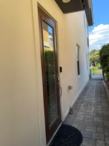 a view of hallway with a door and a window