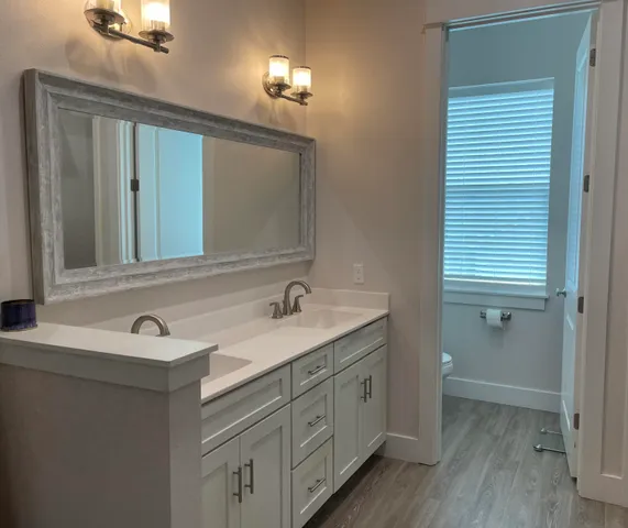 a white toilet sitting next to a window