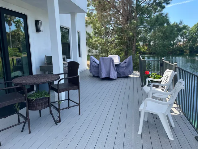 a view of a chairs and table on the wooden deck