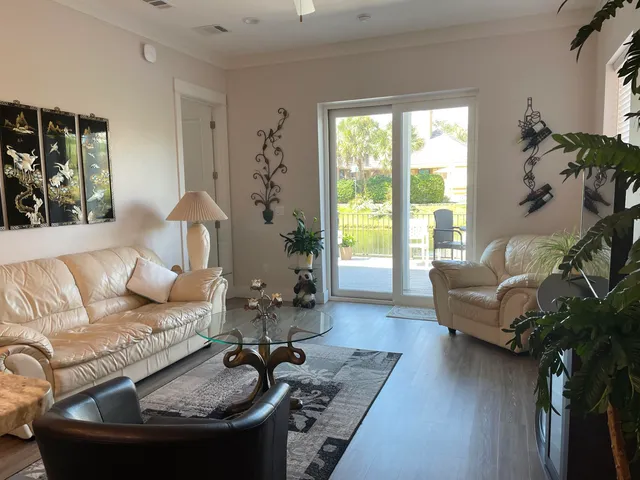 a living room with furniture a chandelier and a rug