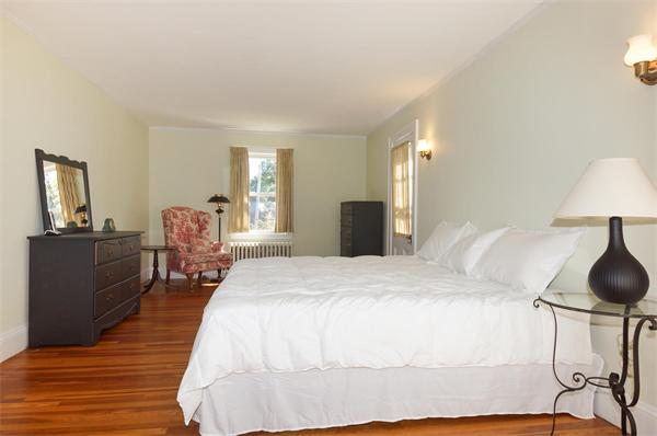 112 Cross Street Belmont, MA 02478 - Photo 13 of 22 a bed room with a bed and a chair
