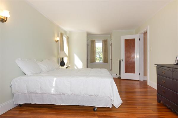 112 Cross Street Belmont, MA 02478 - Photo 14 of 22 a bedroom with a bed and wooden floor