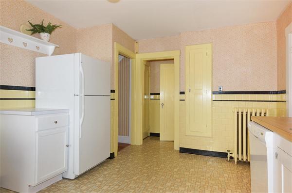 112 Cross Street Belmont, MA 02478 - Photo 6 of 22 a view of a kitchen with white cabinets and refrigerator