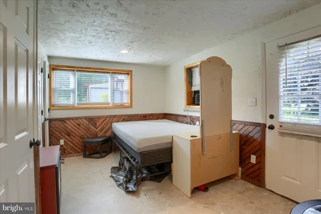 a bedroom with a bed and a table in it