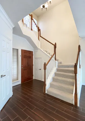 a view of entryway and hall with wooden floor