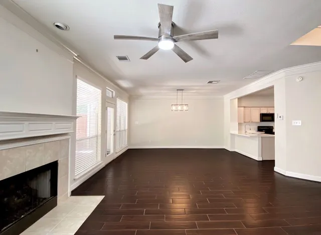 a view of empty room with wooden floor and fireplace