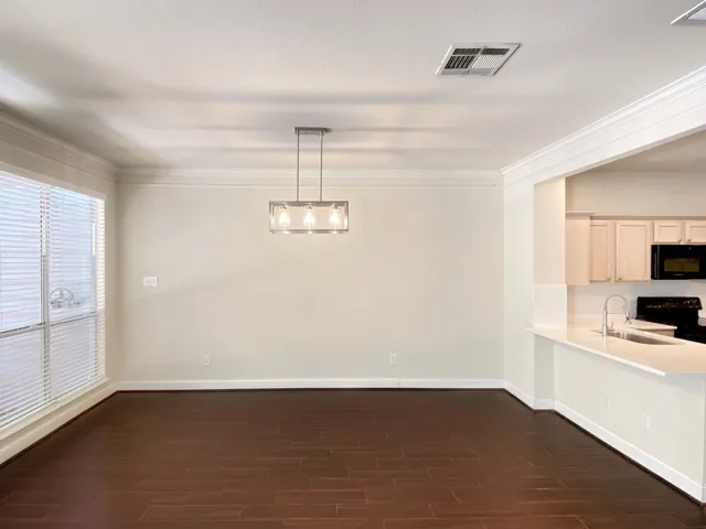 a view of kitchen with sink microwave and stove
