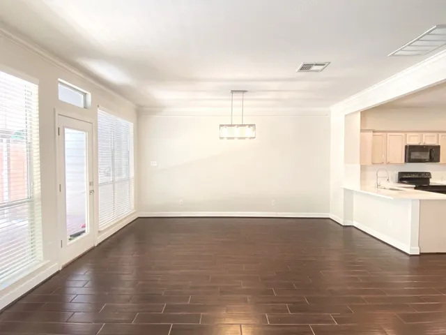 a view of a kitchen with wooden floor and a kitchen