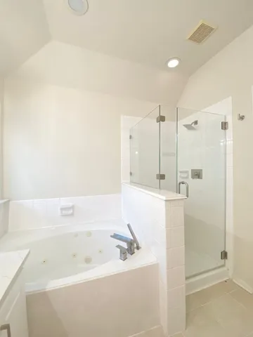 a bathroom with a tub a sink and a shower