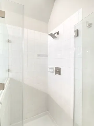 a bathroom with a shower and a glass door