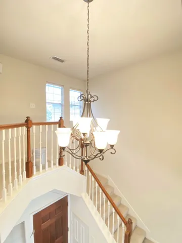 a view of a hallway with furniture and windows