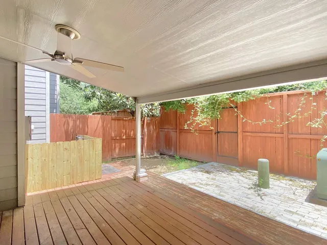 a view of a porch with wooden floor and fence