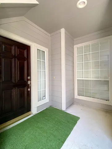 an empty room with windows and cabinet