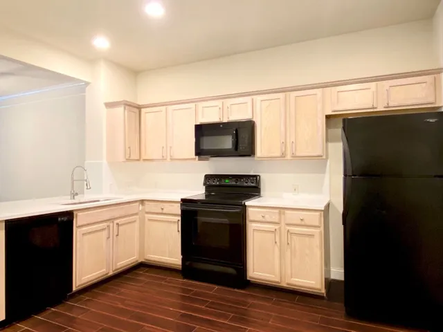 a kitchen with a sink cabinets and stainless steel appliances