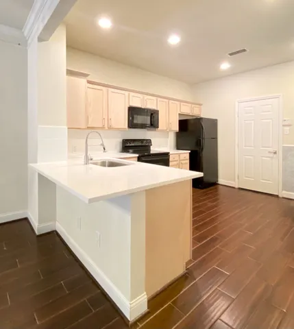 a kitchen with stainless steel appliances a refrigerator sink and microwave