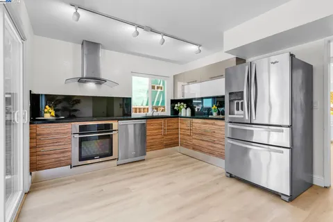 a kitchen with stainless steel appliances and white cabinets