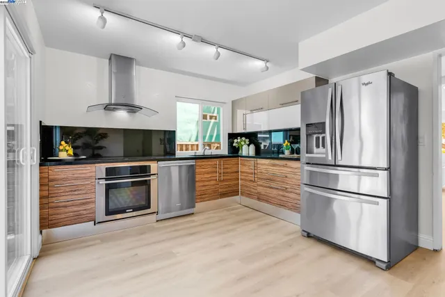 a kitchen with stainless steel appliances and white cabinets