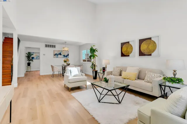 a living room with furniture and painting on the wall