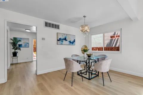 a view of a dining room with furniture wooden floor and chandelier