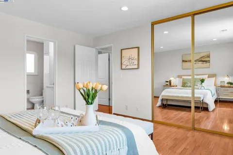 a bedroom with a bed and ceiling fan