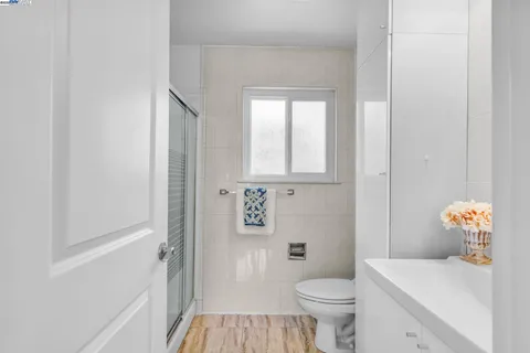a bathroom with a toilet a sink and a window