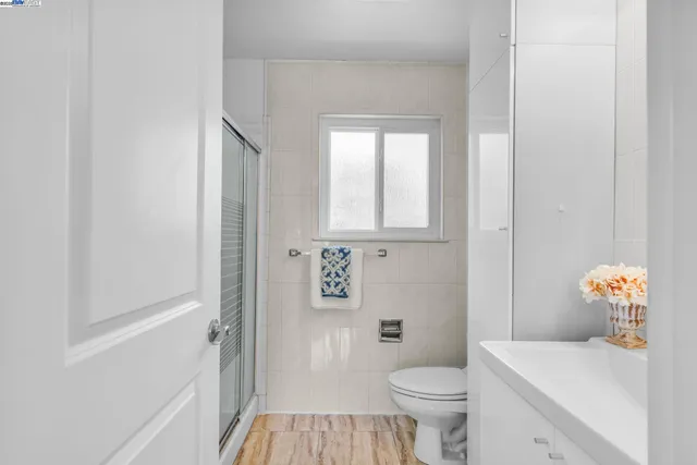 a bathroom with a toilet a sink and a window