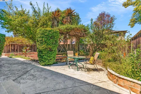 a view of a patio with table and chairs and potted plants